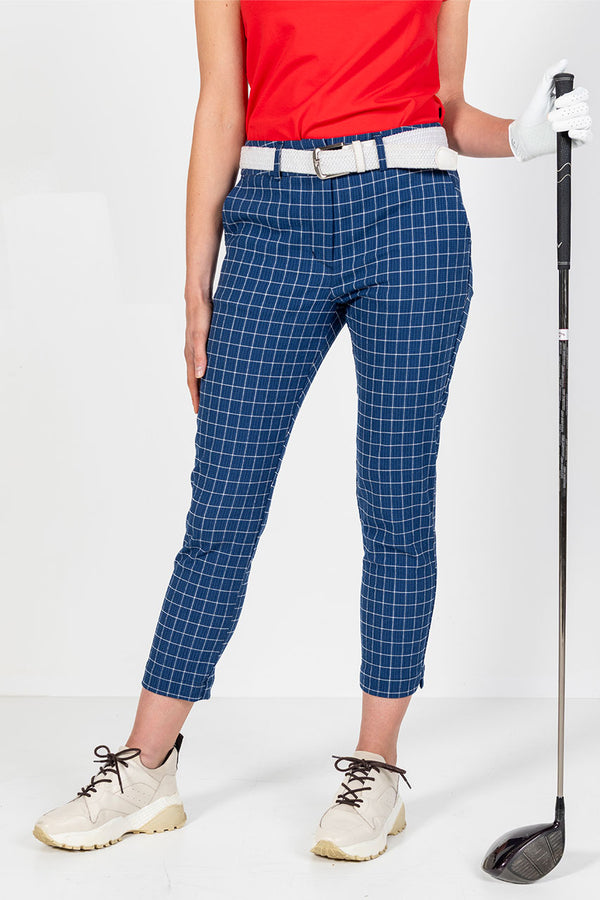 Woman in  navy and white window pane check golf pants