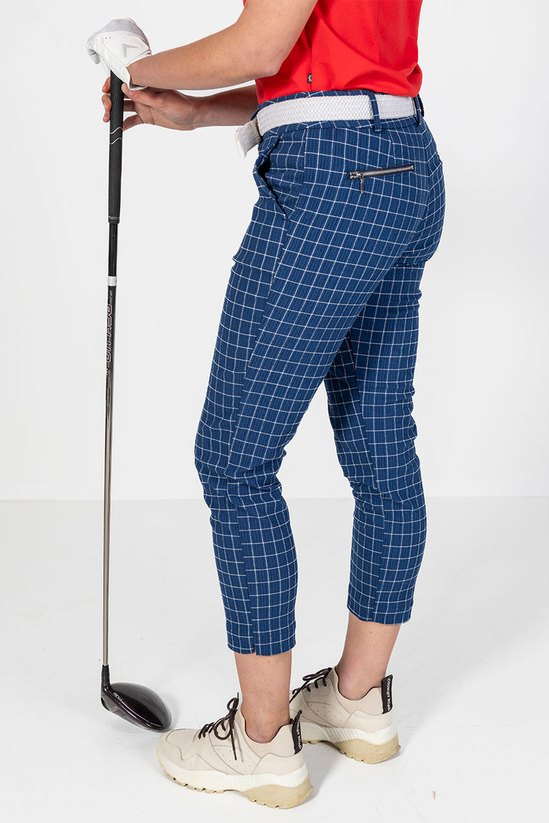 Woman in navy and white check golf pants