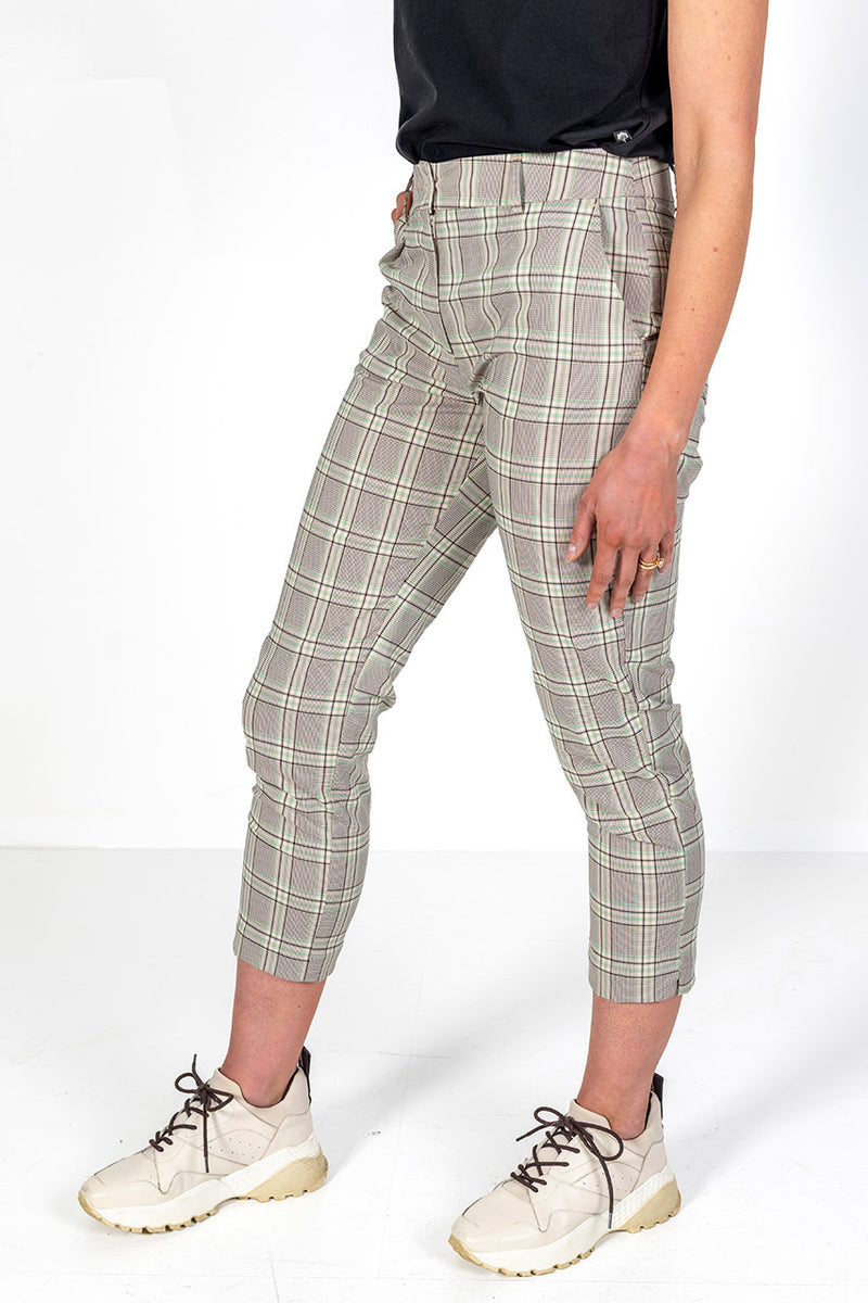 Woman wearing green,stone and black plaid stretch golf pants 